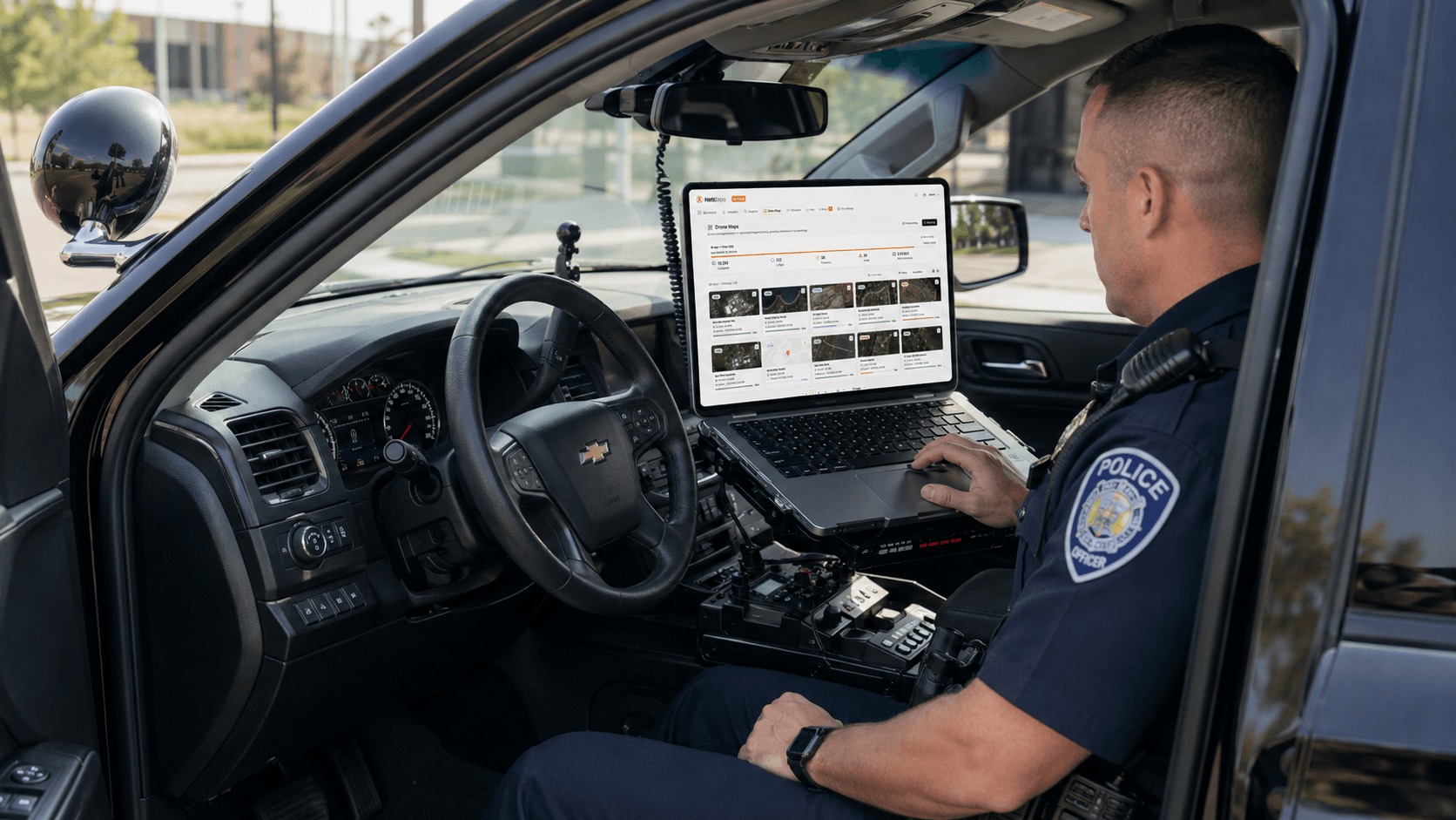 A police officer reviewing AirMap from a laptop inside a patrol vehicle